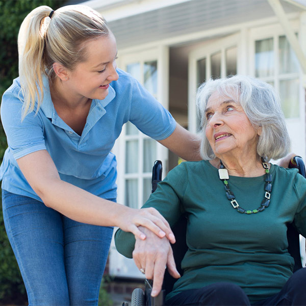 young woman chatting to elderly woman