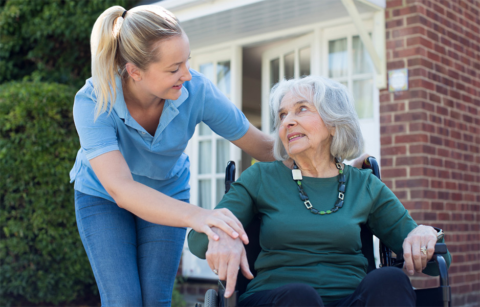 young woman chatting to elderly woman