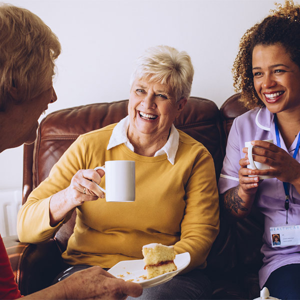 young woman chatting to elderly woman