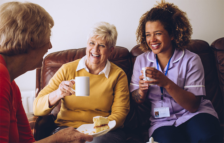 young woman chatting to elderly woman