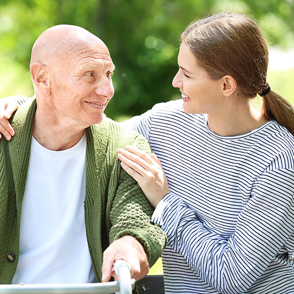a young woman embracing an elderly man