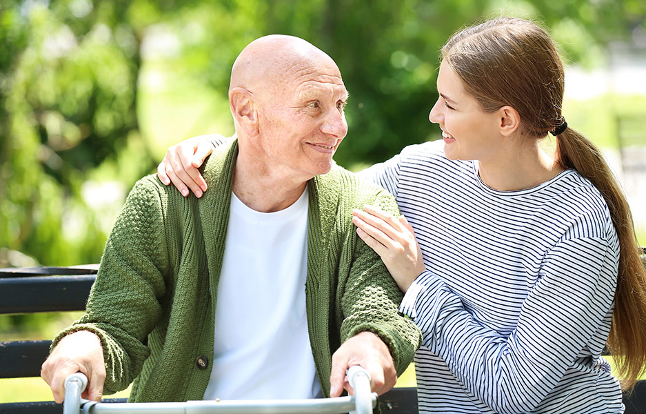 a young woman embracing an elderly man